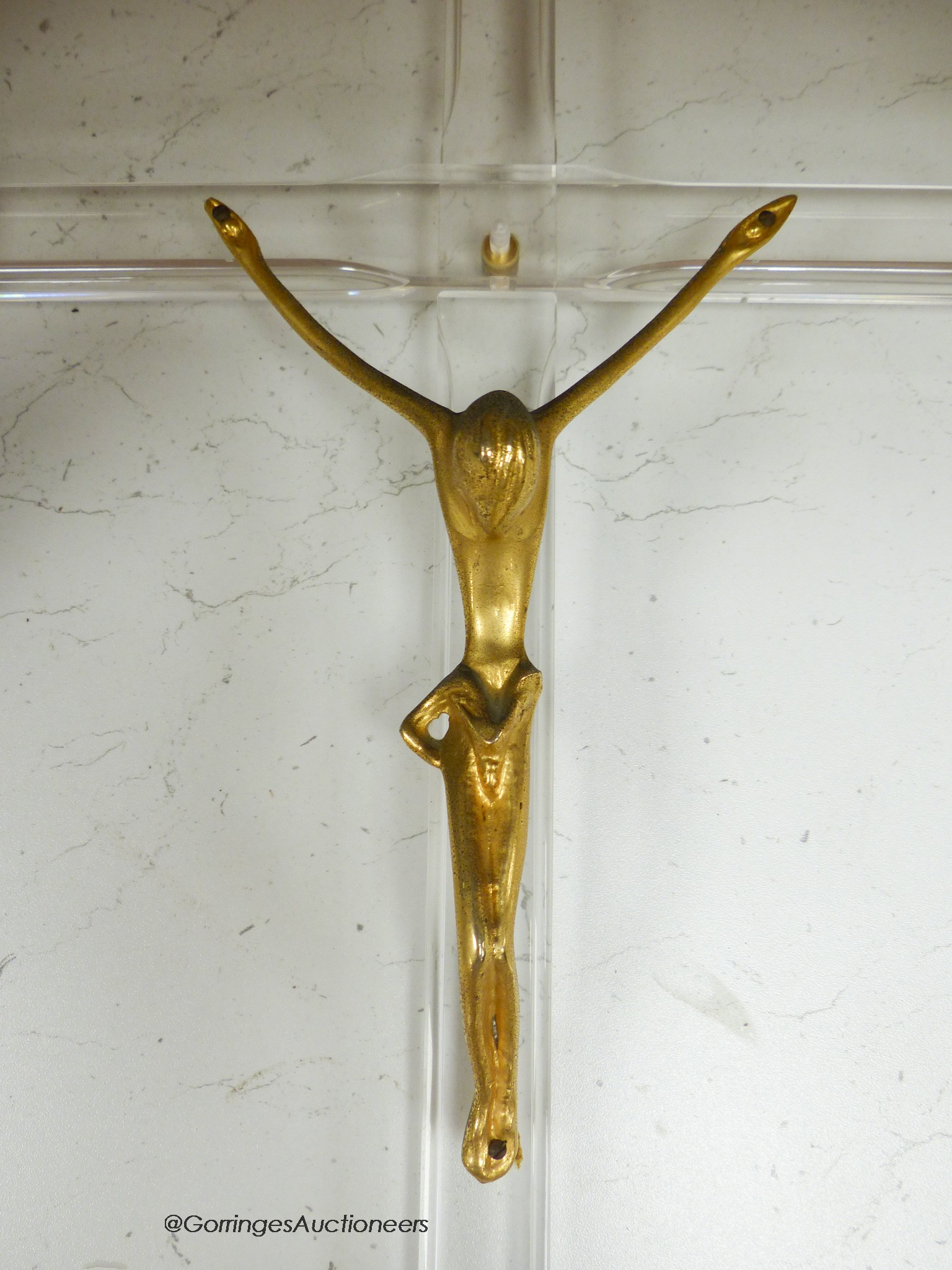 A gilt metal and perspex crucifix formerly attributed to Philip Stark, 58cm long